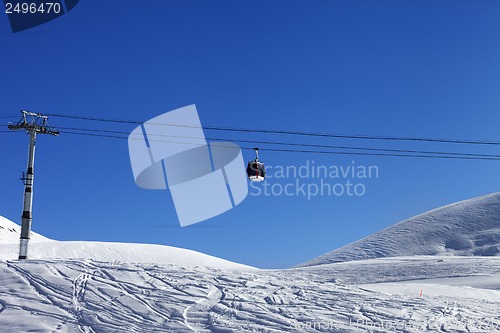 Image of Gondola lift and off piste slope at nice day
