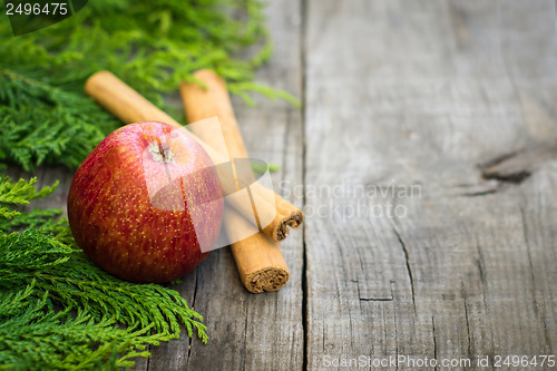 Image of Red Apple with cinnamon sticks