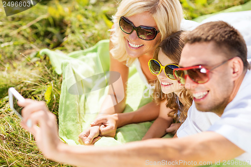 Image of happy family with camera taking picture