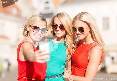 Image of beautiful girls taking picture in the city