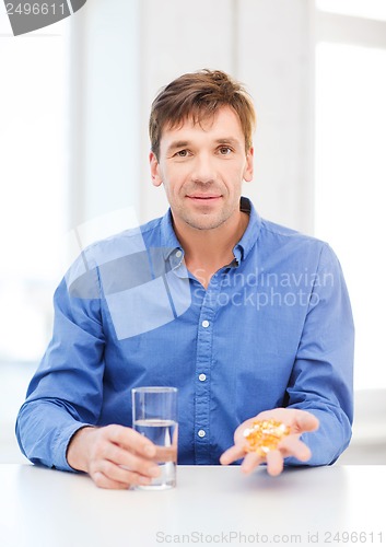 Image of man at home showing lot of pills