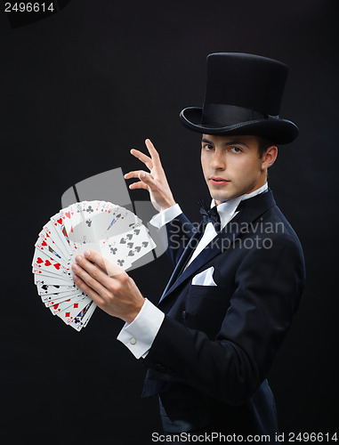 Image of magician showing trick with playing cards