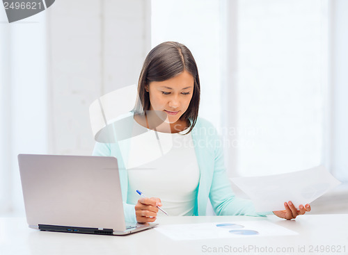 Image of asian businesswoman with laptop and documents
