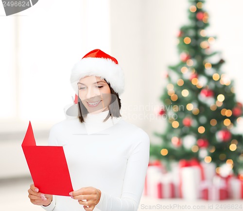Image of woman in santa helper hat with blank red postcard