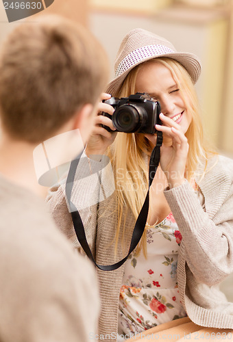 Image of couple taking photo picture in cafe