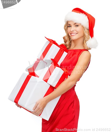 Image of woman in santa helper hat with many gift boxes