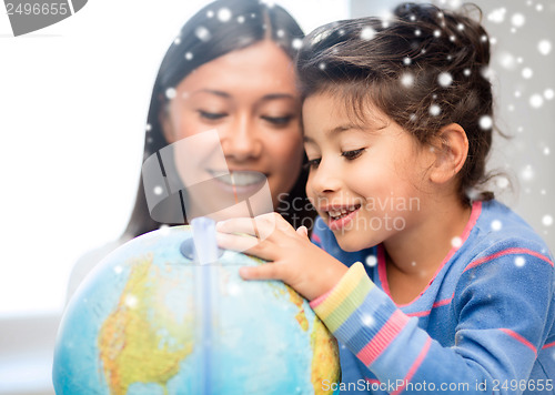 Image of mother and daughter with globe