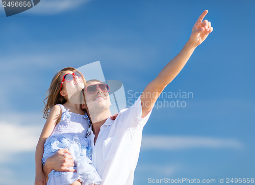 Image of happy father and child in sunglasses over blue sky
