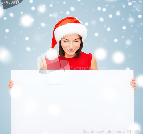 Image of woman in santa helper hat with blank white board