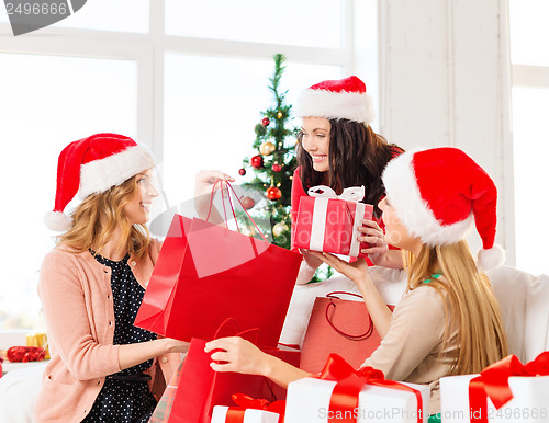 Image of women in santa helper hats with shopping bags