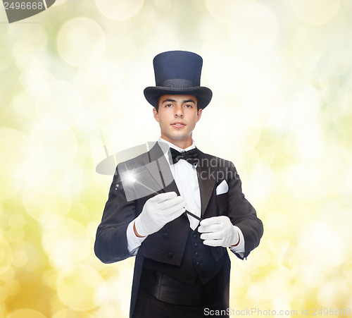 Image of magician in top hat with magic wand showing trick