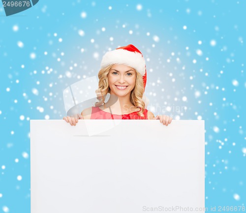 Image of woman in santa helper hat with blank white board