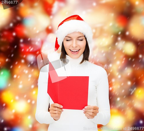 Image of woman in santa helper hat with blank red postcard