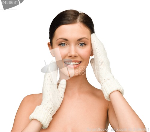 Image of smiling young woman in white mittens