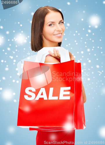 Image of woman in red dress with shopping bags