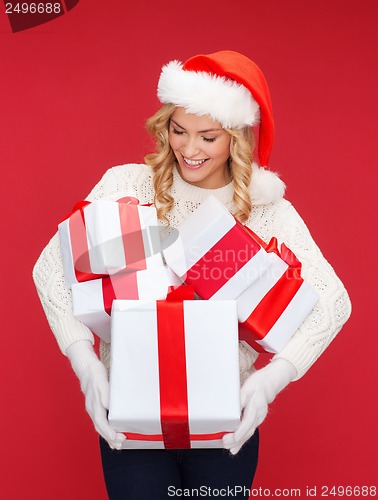 Image of woman in santa helper hat with many gift boxes