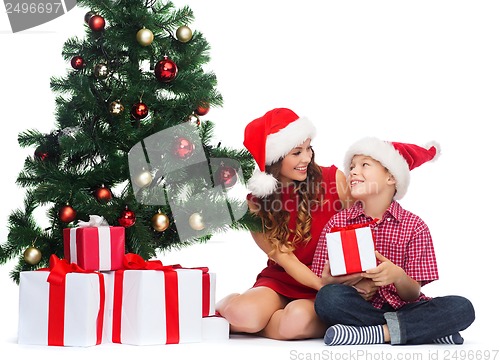 Image of happy mother and child boy with gift boxes