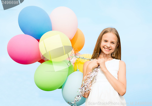 Image of happy girl with colorful balloons