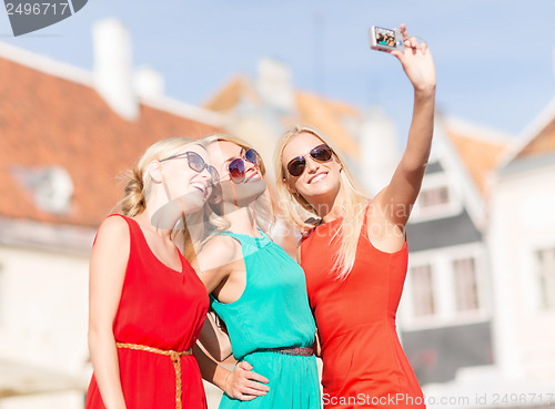 Image of beautiful girls taking picture in the city
