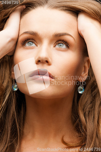 Image of eautiful calm woman with beautiful earrings