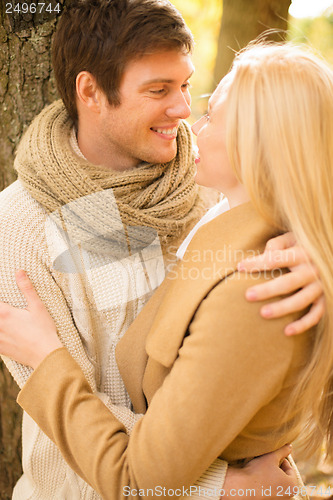 Image of romantic couple kissing in the autumn park