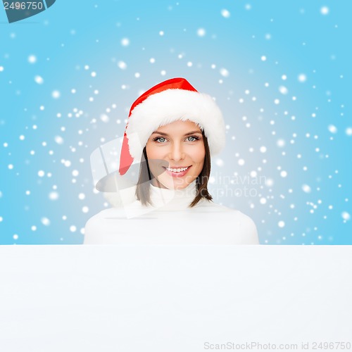 Image of woman in santa helper hat with blank white board