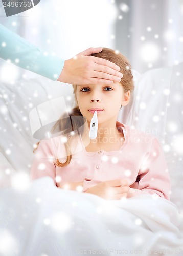 Image of ill girl child with thermometer and caring mother