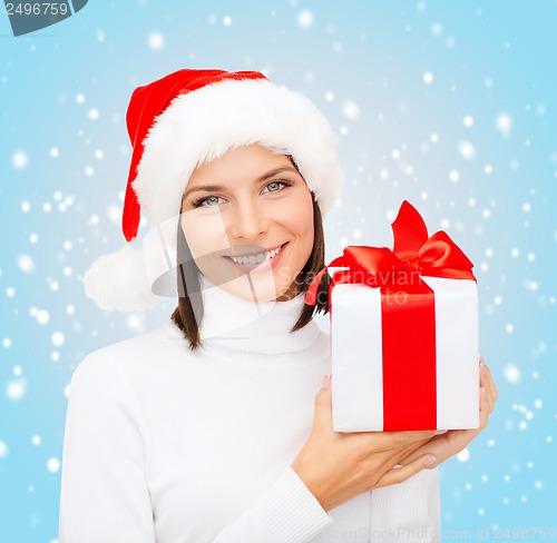 Image of smiling woman in santa helper hat with gift box