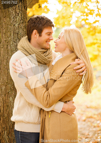 Image of romantic couple kissing in the autumn park
