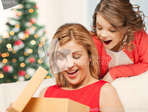 Image of happy mother and child girl with gift box