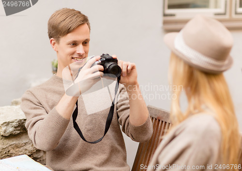 Image of couple taking photo picture in cafe