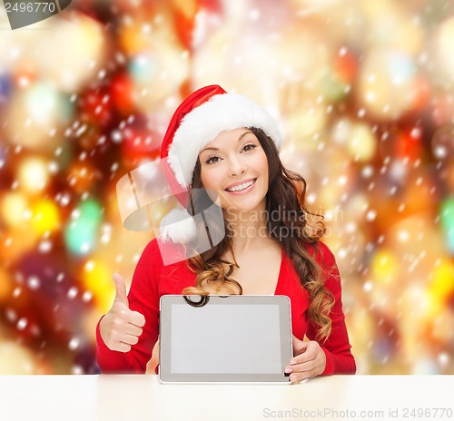 Image of woman in santa helper hat with tablet pc