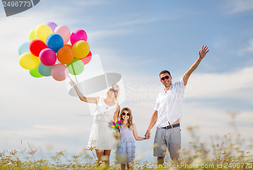 Image of family with colorful balloons