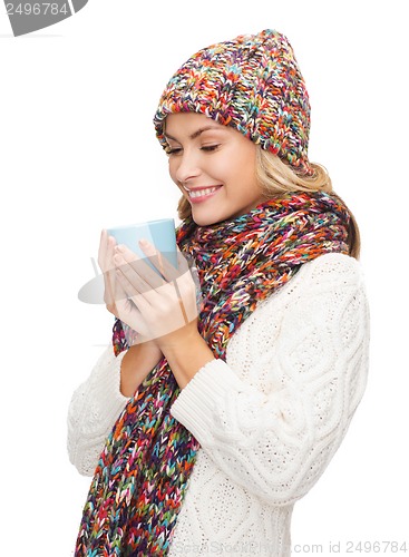 Image of woman in hat with red tea or coffee mug