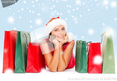 Image of woman in red shirt with shopping bags