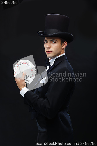 Image of magician showing trick with playing cards