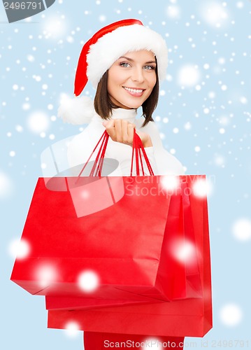 Image of woman in santa helper hat with shopping bags