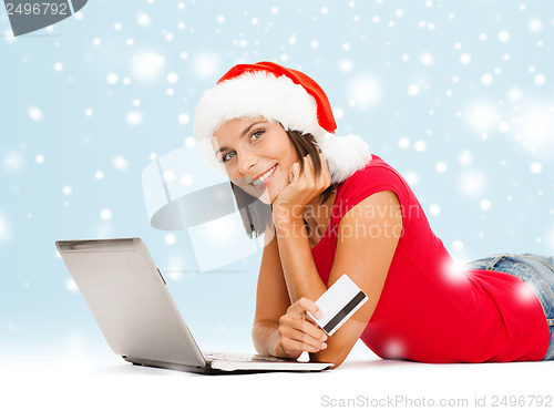 Image of woman in santa hat with laptop and credit card