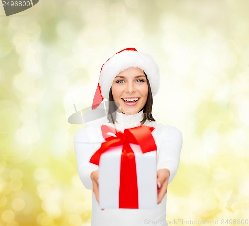 Image of smiling woman in santa helper hat with gift box