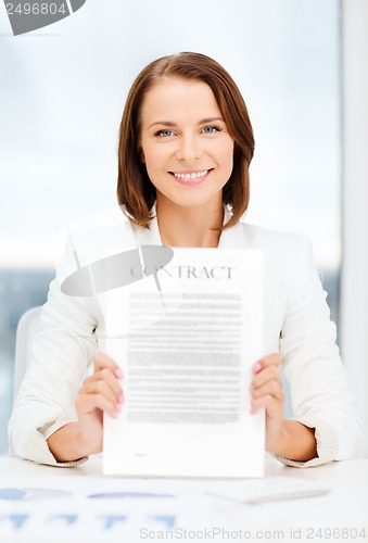 Image of happy businesswoman holding contract