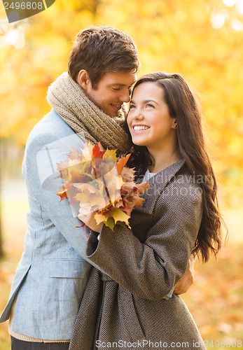 Image of romantic couple kissing in the autumn park