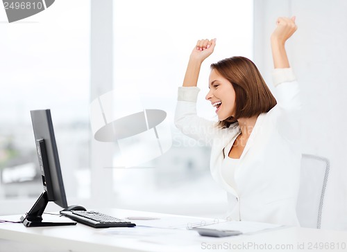 Image of businesswoman with computer in office