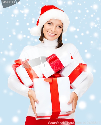 Image of woman in santa helper hat with many gift boxes