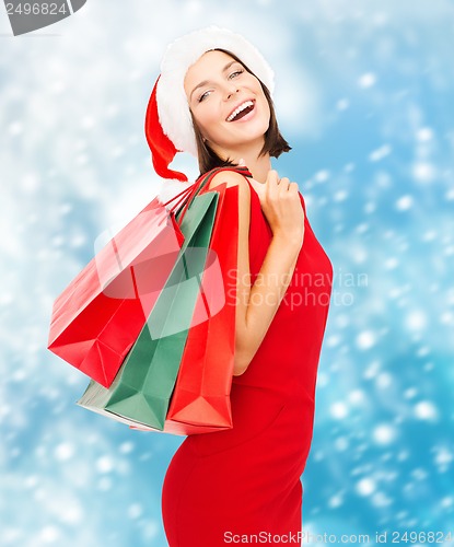 Image of woman in red dress with shopping bags