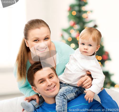 Image of happy parents playing with adorable baby
