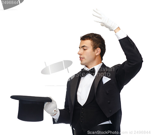 Image of magician in top hat showing trick