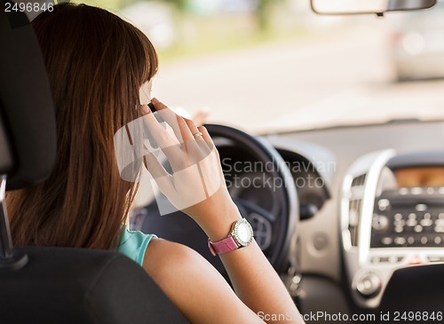 Image of woman using phone while driving the car