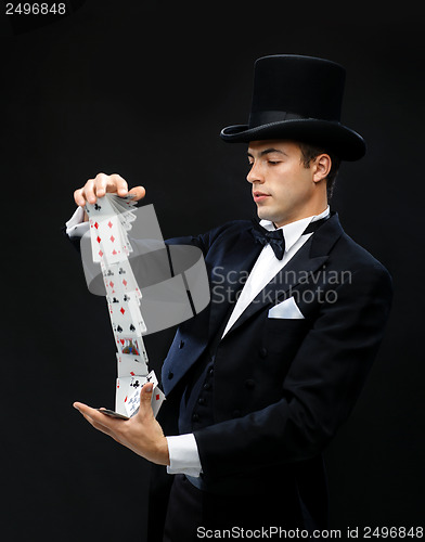 Image of magician showing trick with playing cards