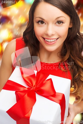 Image of smiling woman in red dress with gift box