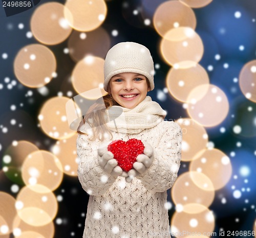 Image of girl in winter clothes with small red heart